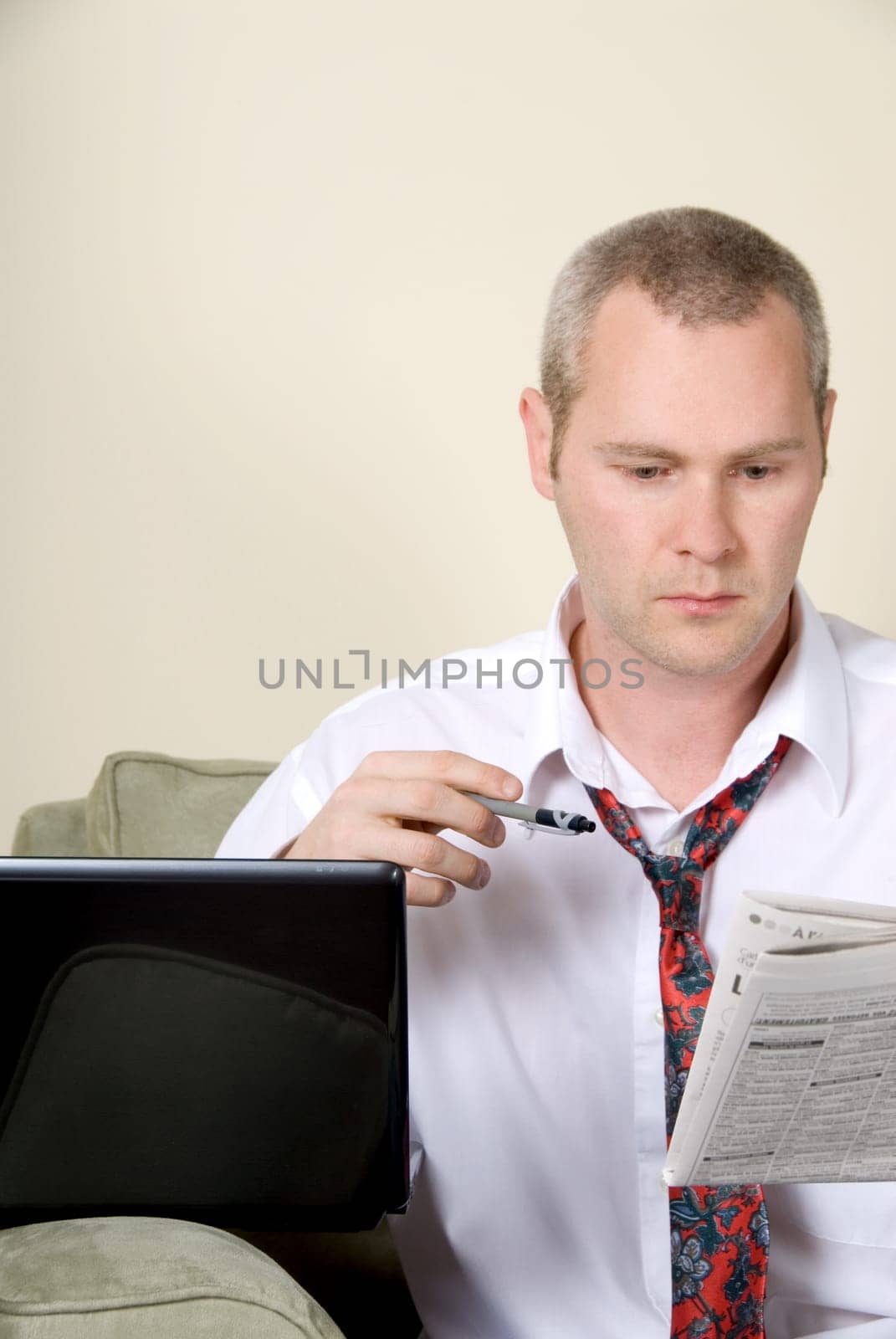 man with white shirt reading a newspaper