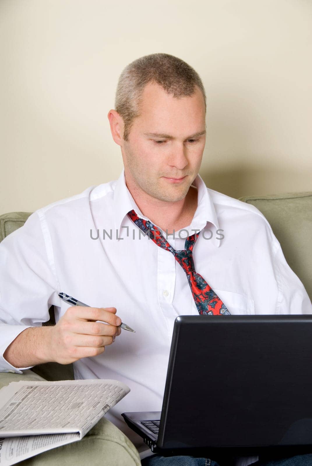 businessman back from work on the couch with laptop