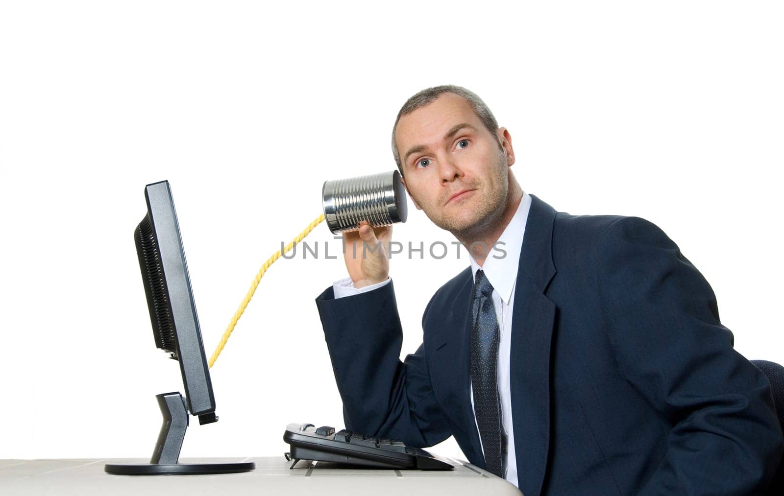 man in suit listening to a tin can phone