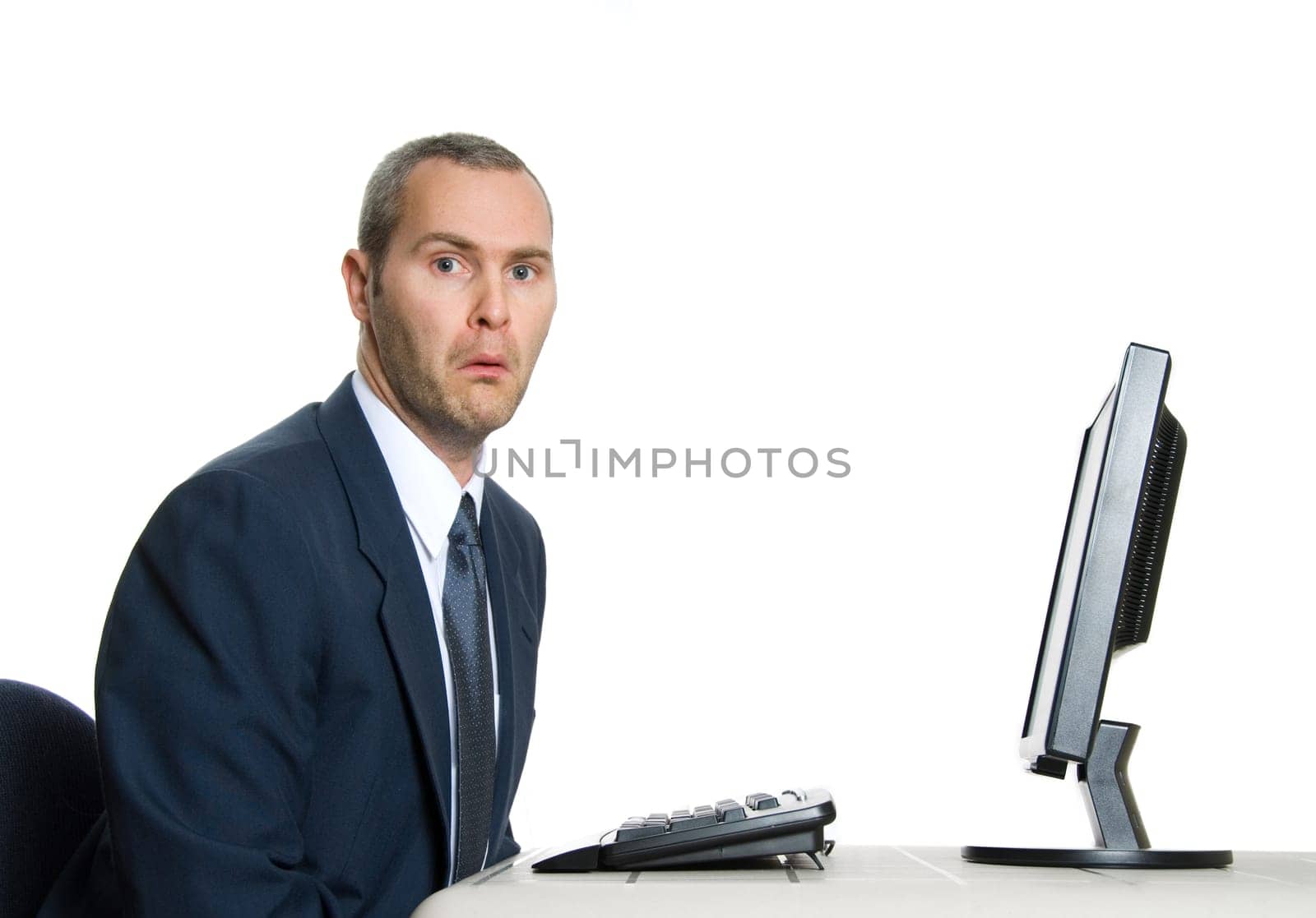 unhappy man in blue suit at office computer