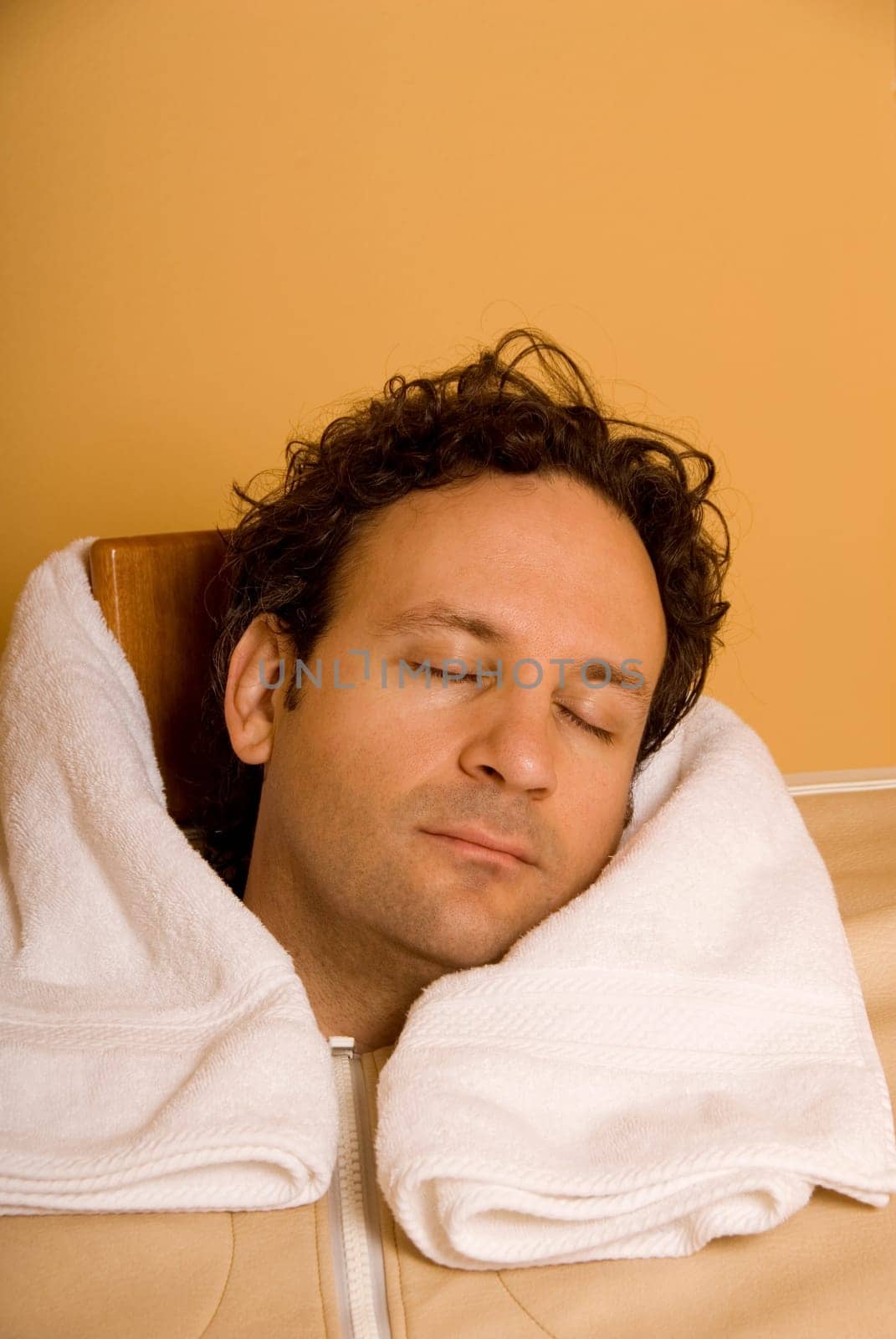man sleeping in personal sauna at spa