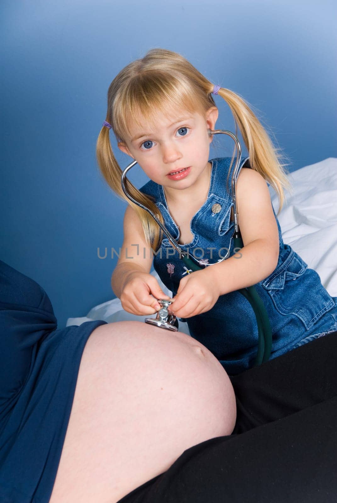 cute blond boy listening to the unborn child