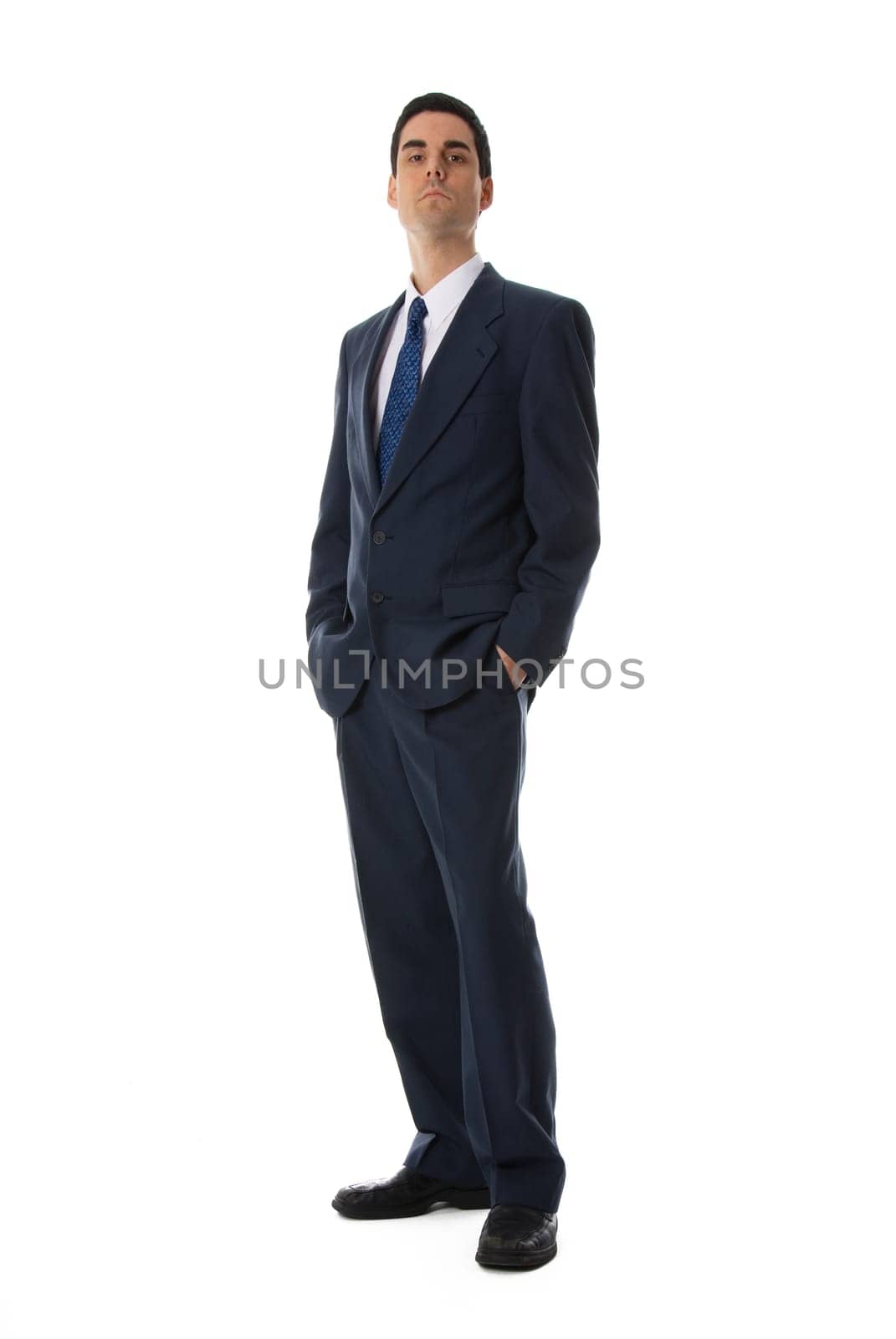 businessman with his hands in his pockets on white