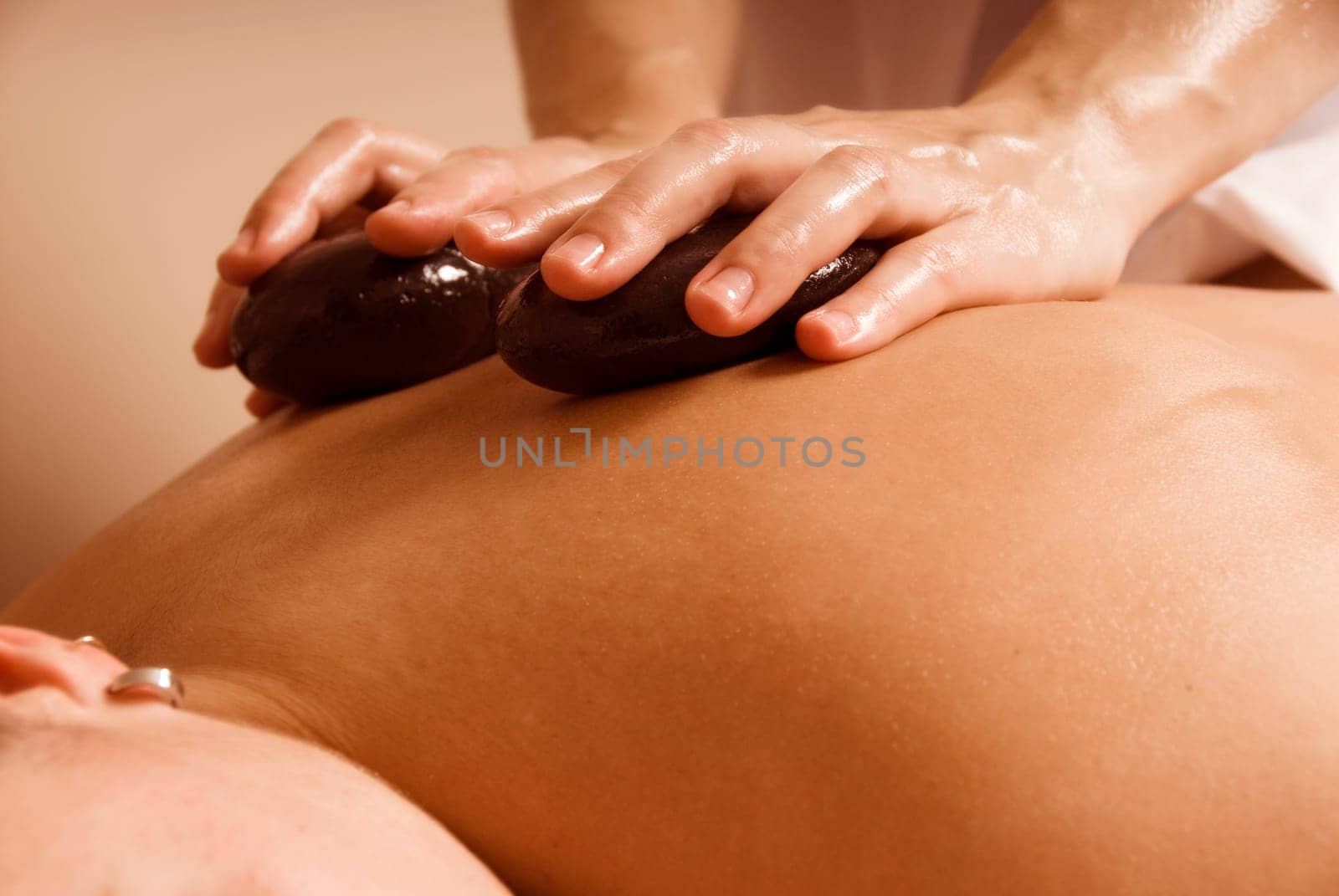 woman in a day spa getting a stone treatment