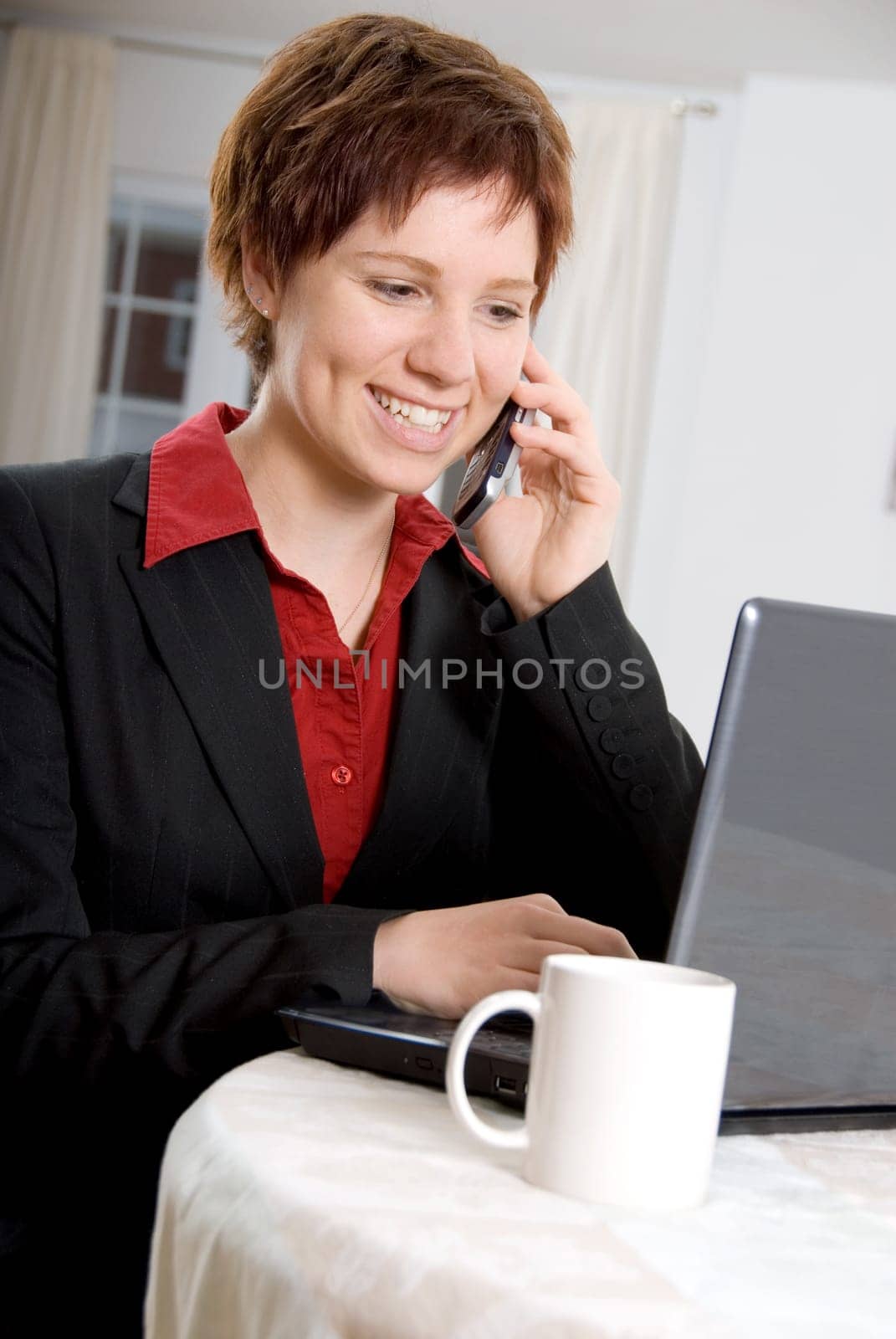 woman on the phone and laptop at the same time
