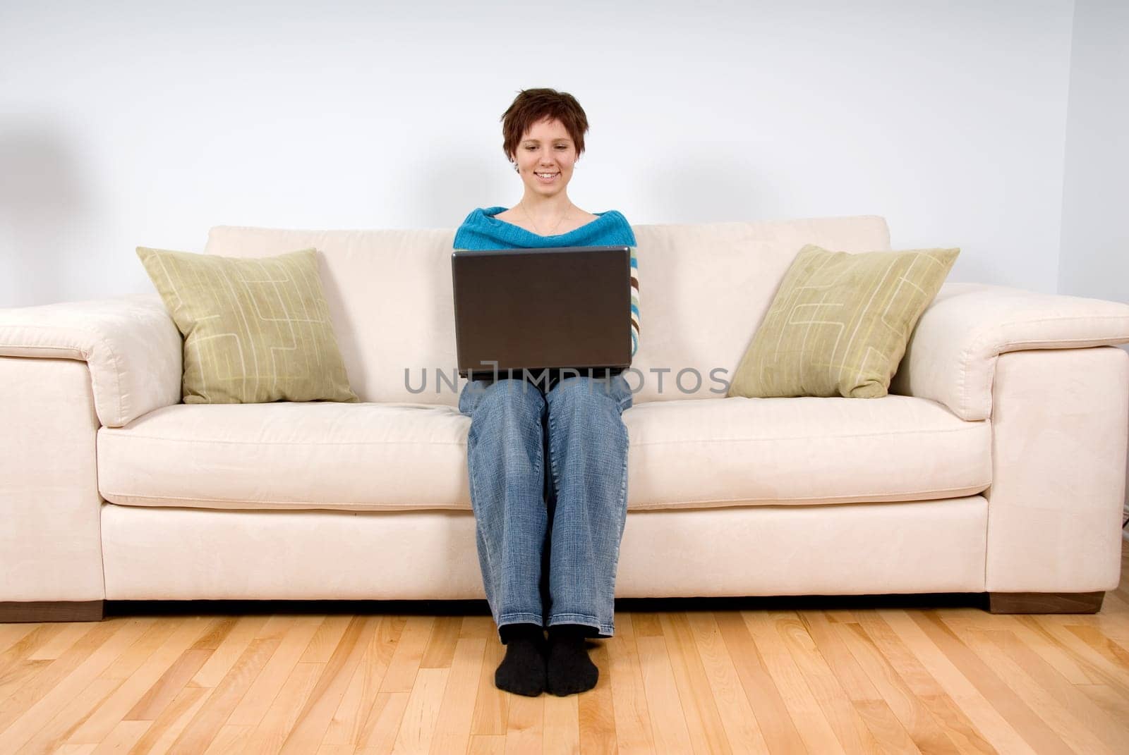 woman on her laptop sitting on the sofa