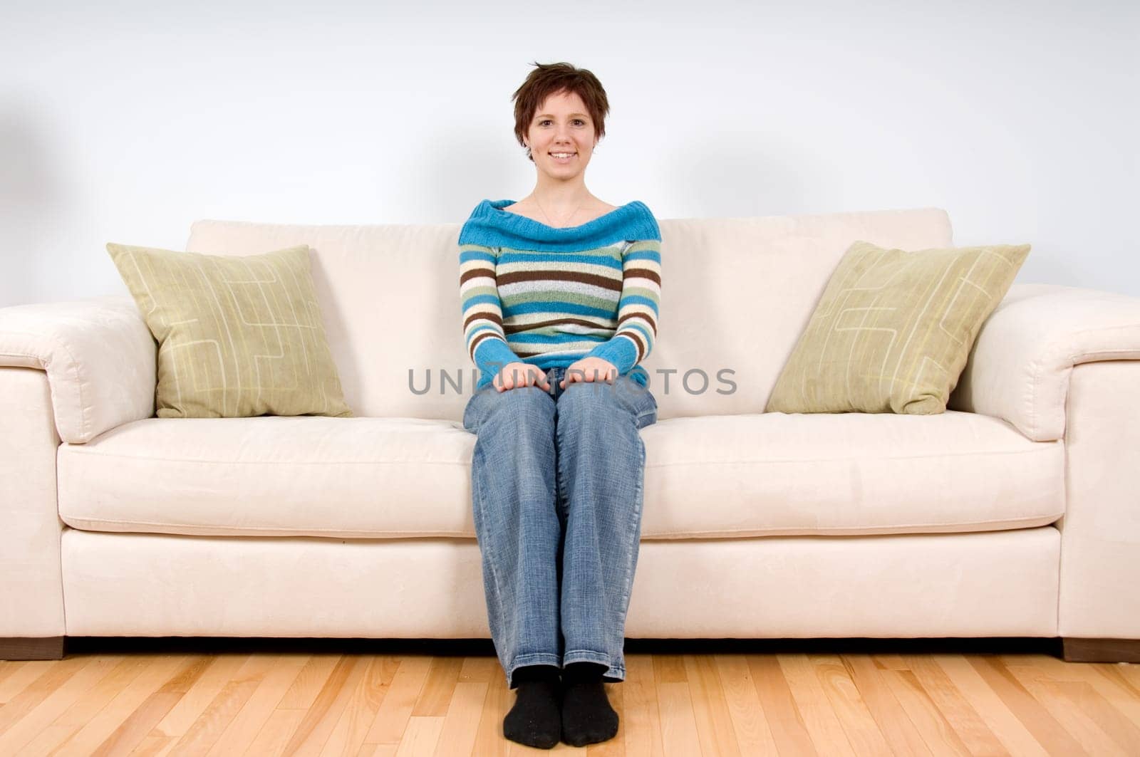 cute girl ona sofa looking at a camera