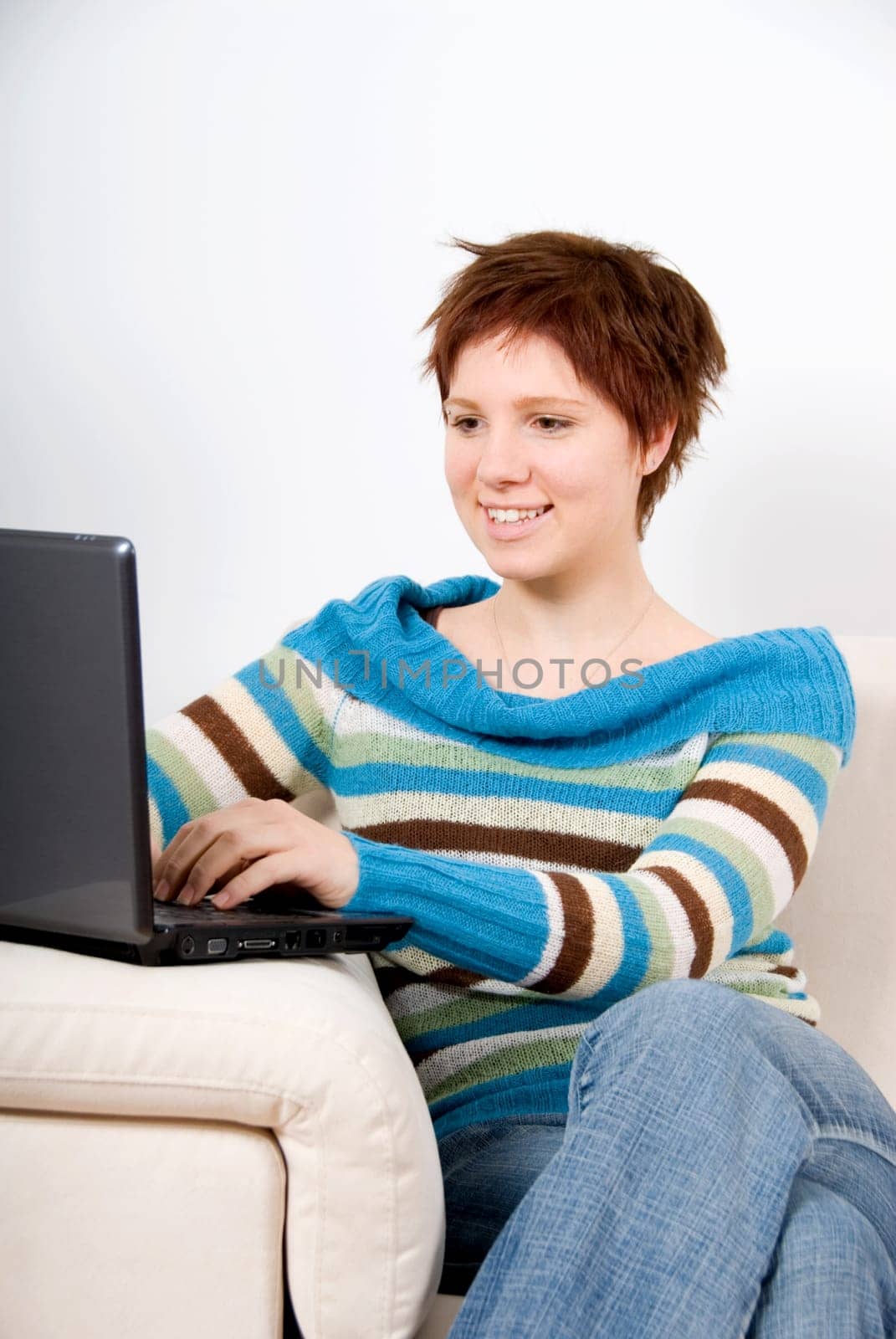 cute woman on the couch with her laptop