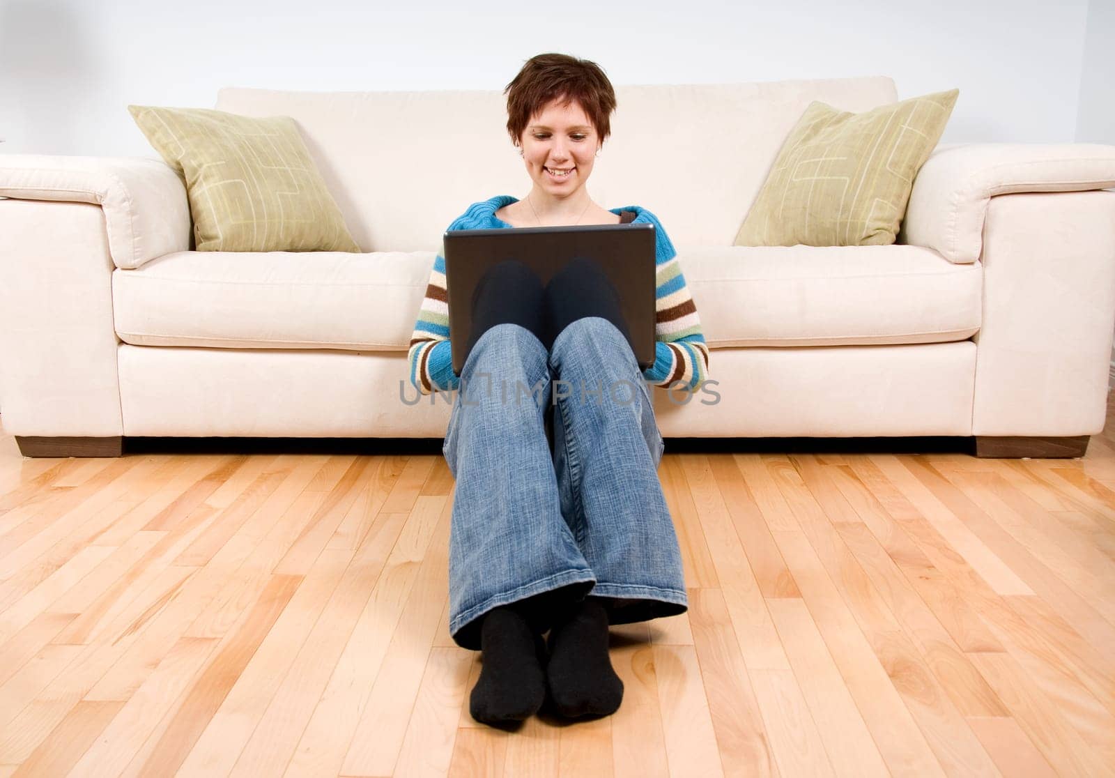 cute woman with her laptop working on the floor