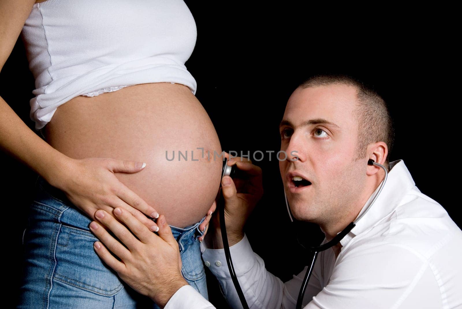 future father listening to the baby's heart beat