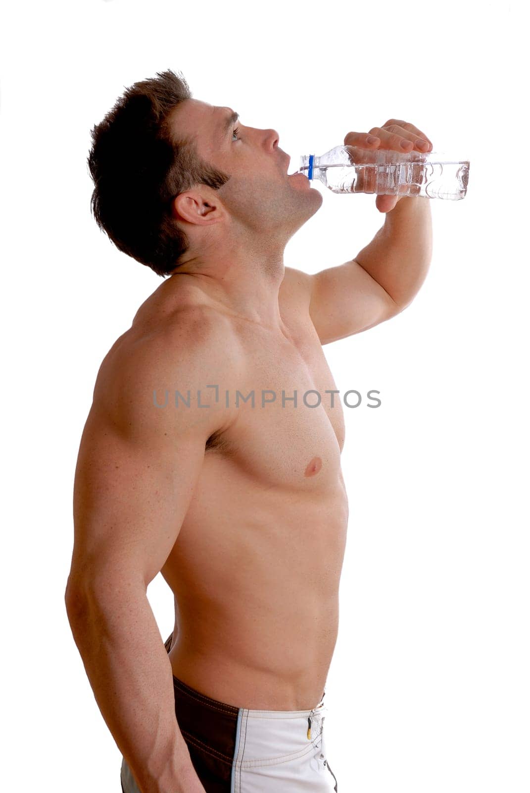 topless man doing a workout and drinking water