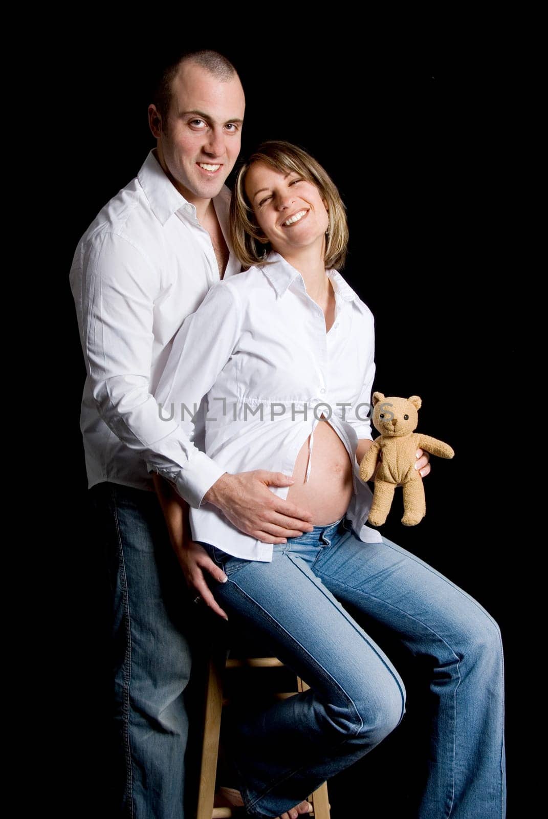 happy smiling couple with a toy teady bear