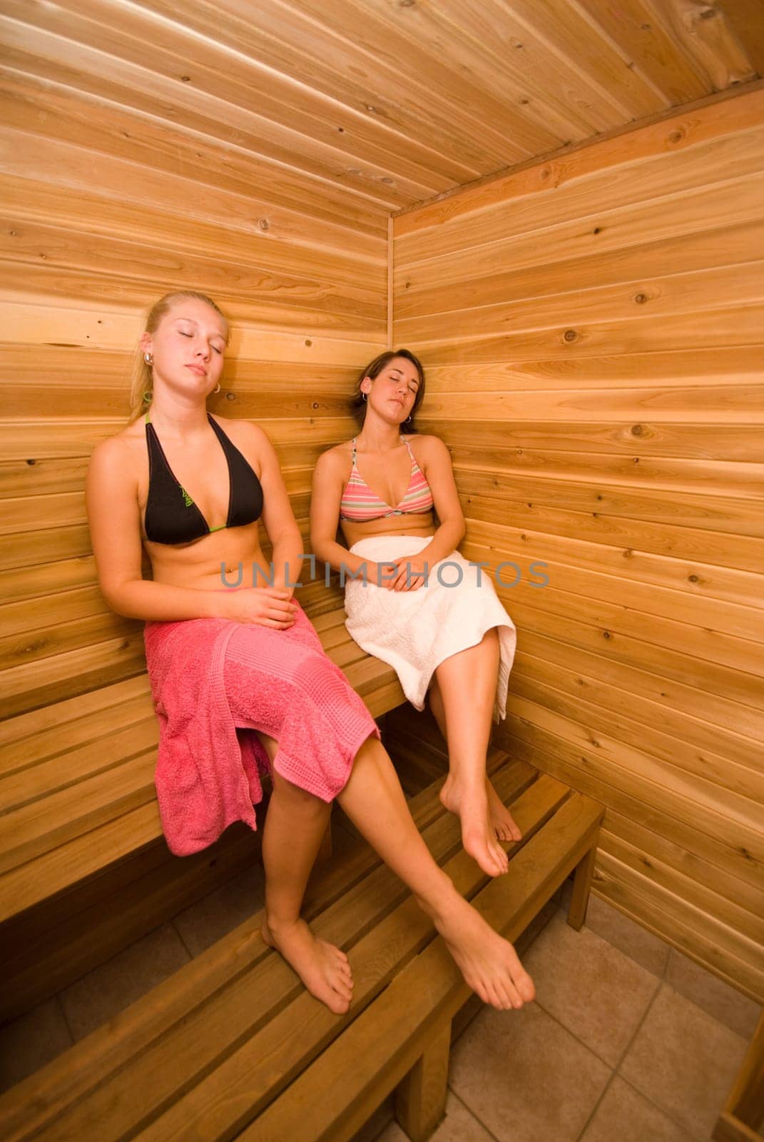 two women relaxing in the wood sauna