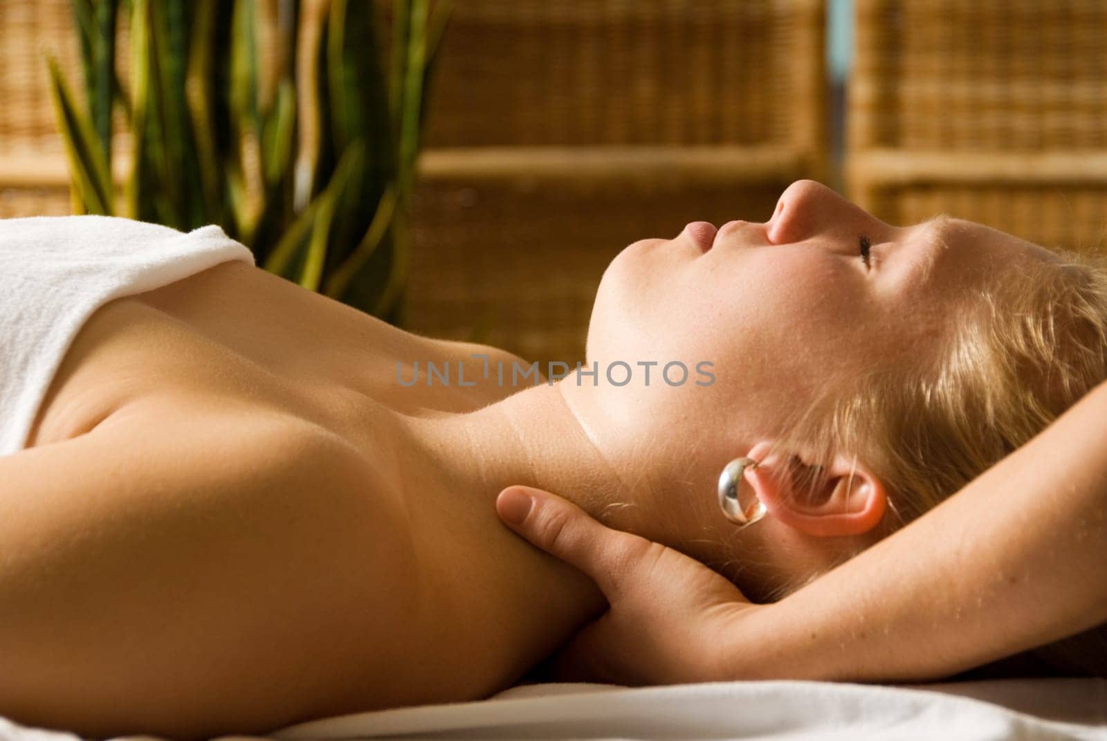 woman in a day spa getting a neck massage by therapist