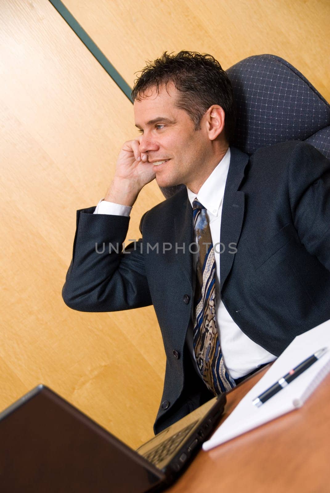 Businessman in a board room on the cell phone