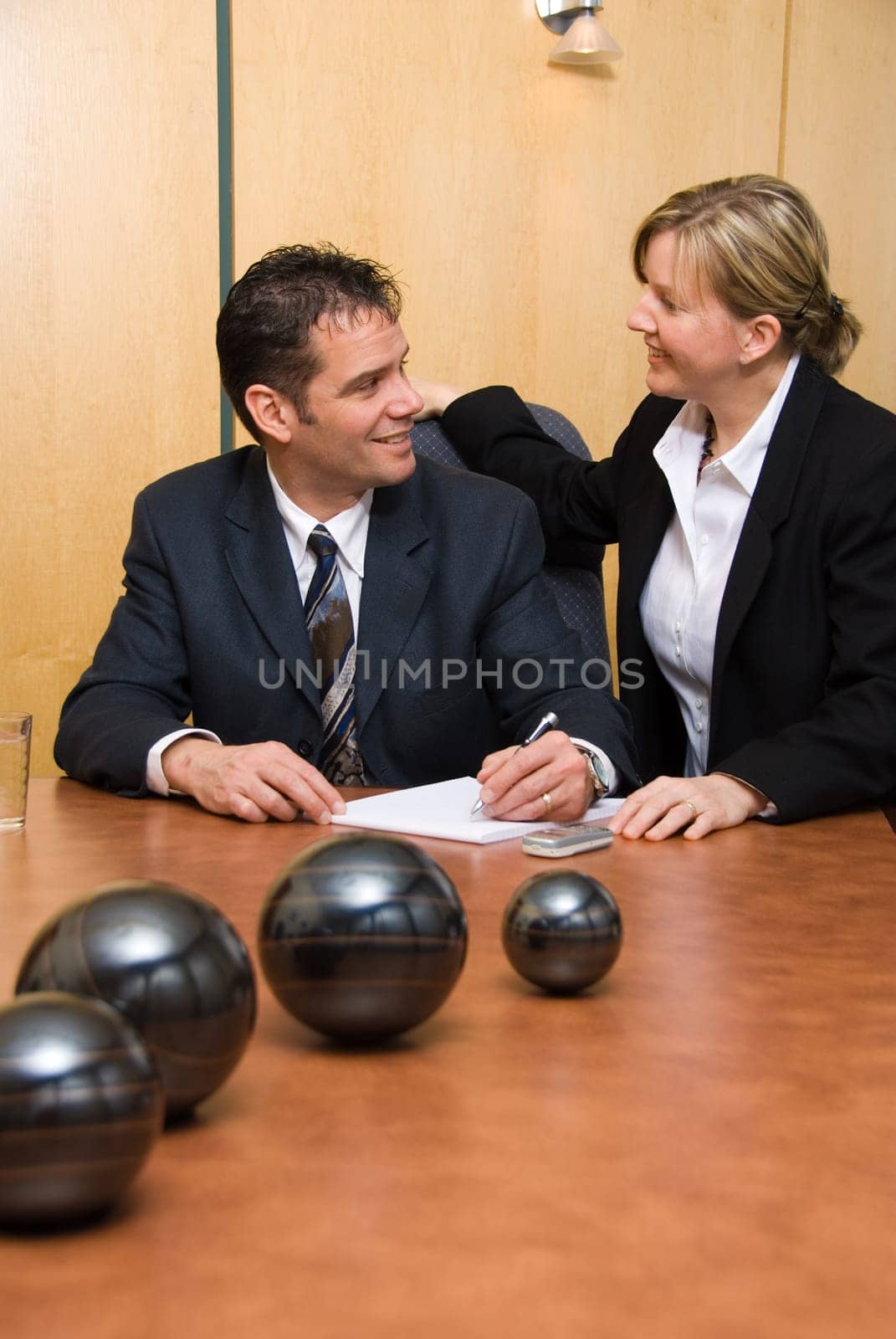 man and woman in a room with a paper pad writing