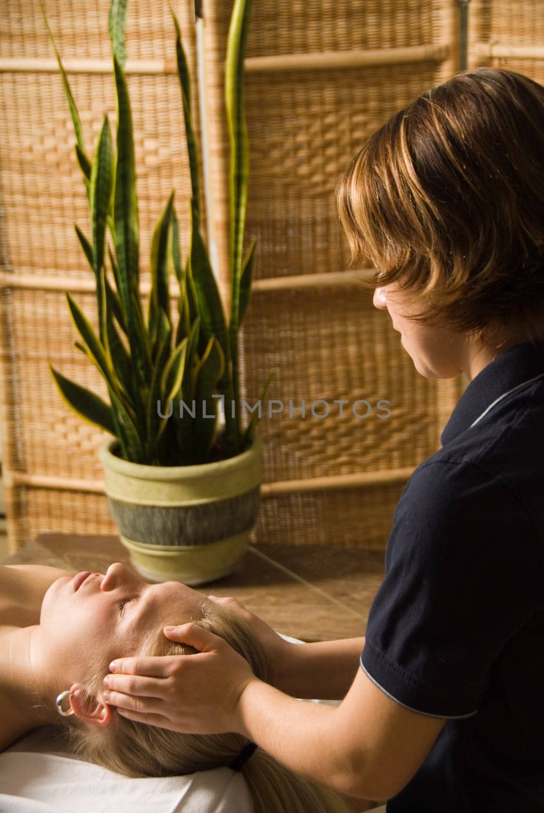 woman in a day spa getting a massage by therapist