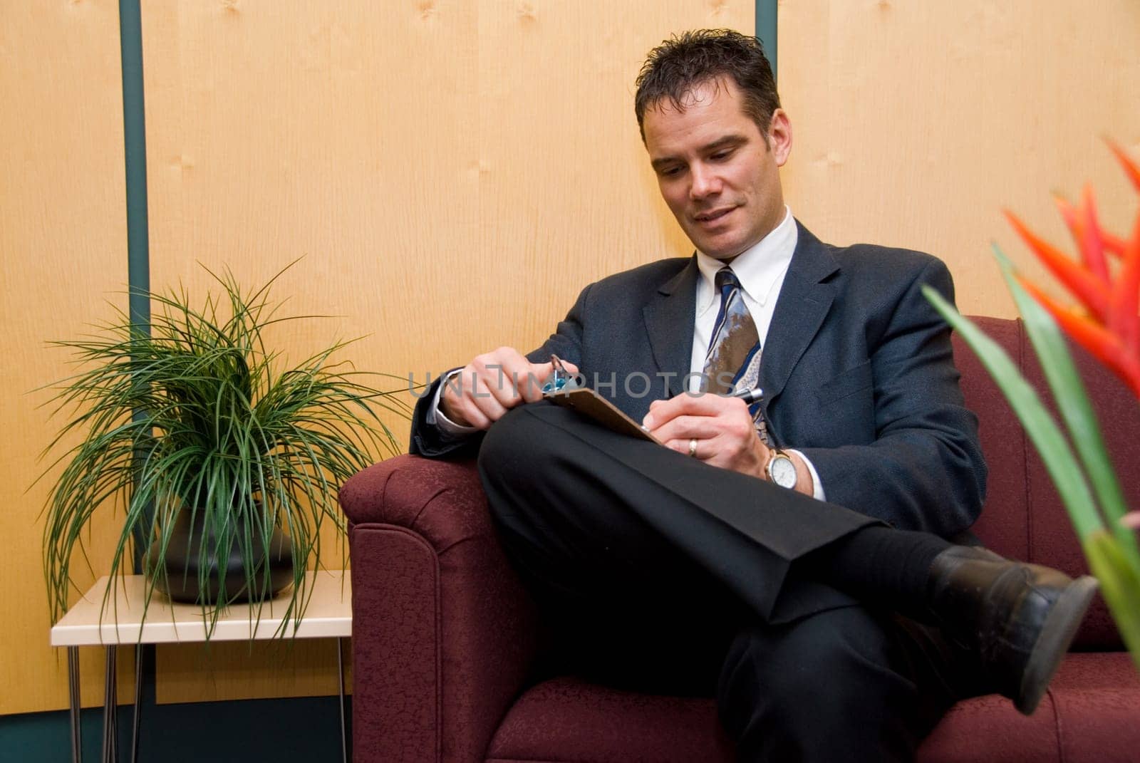 business man taking notes in a reception area