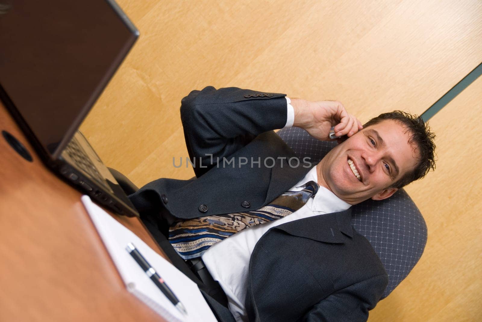 Businessman in a board room on the cell phone