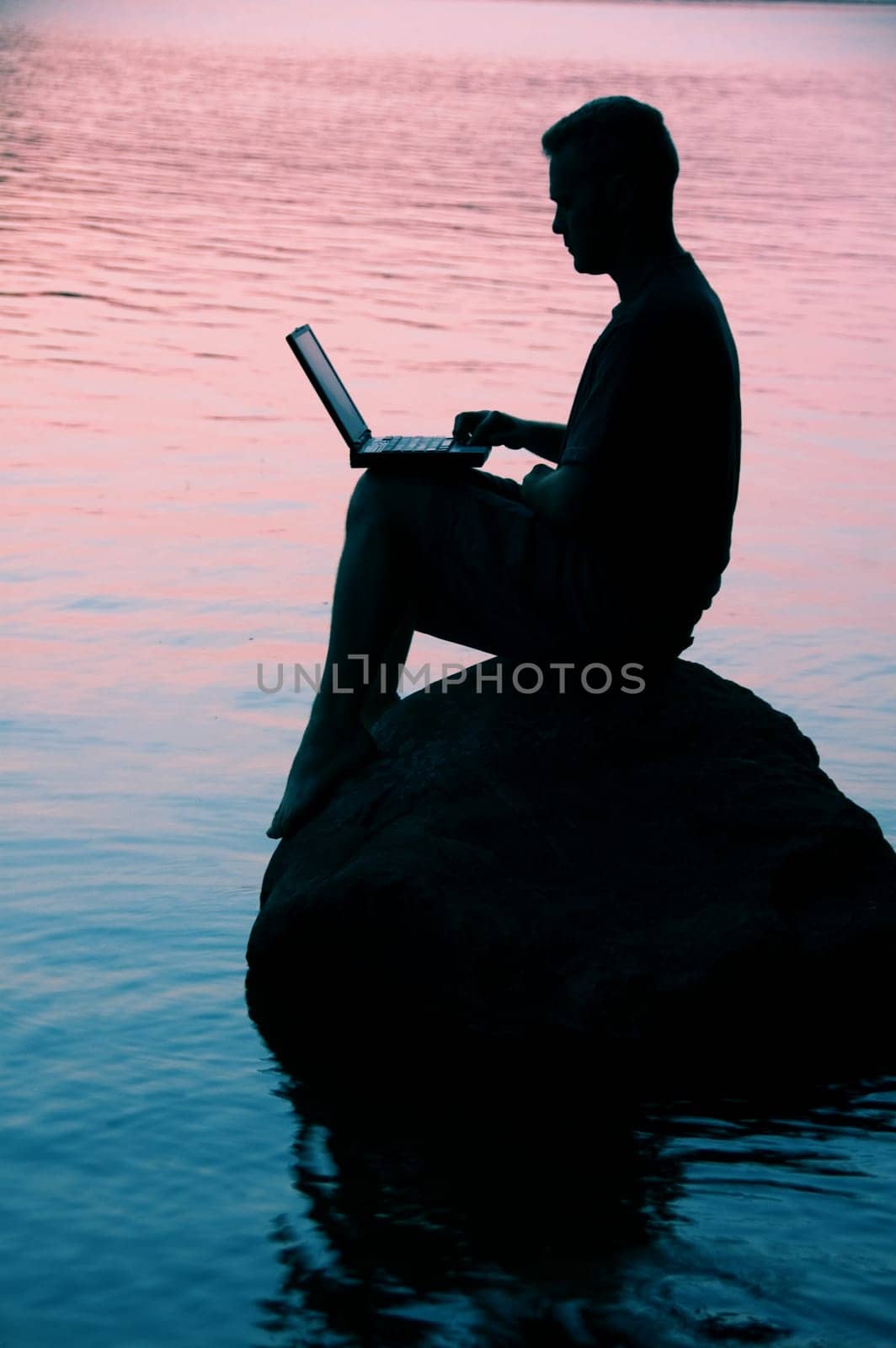 sitting on a rock on a lake
