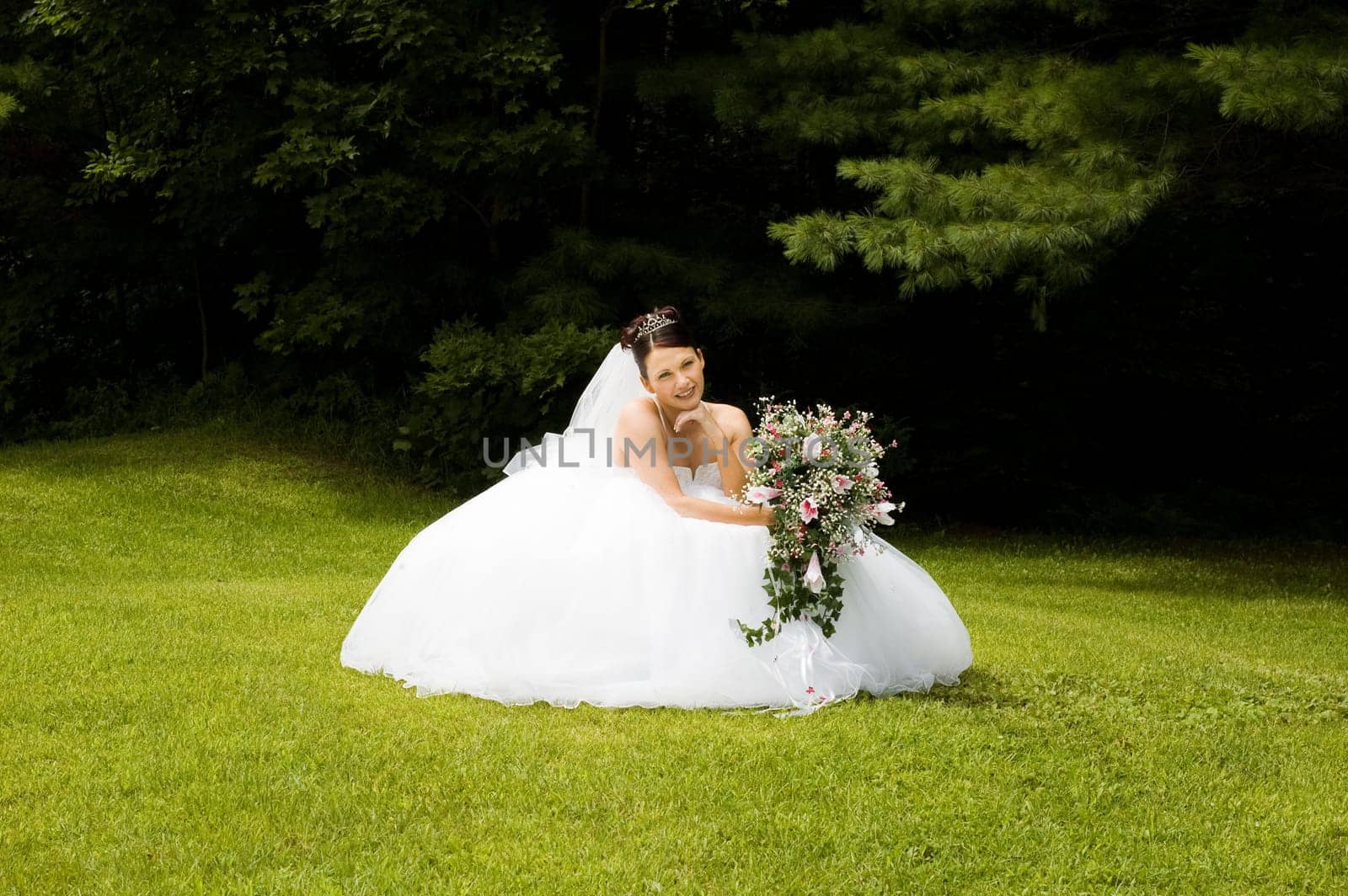 White Bride at her wedding posing with veil