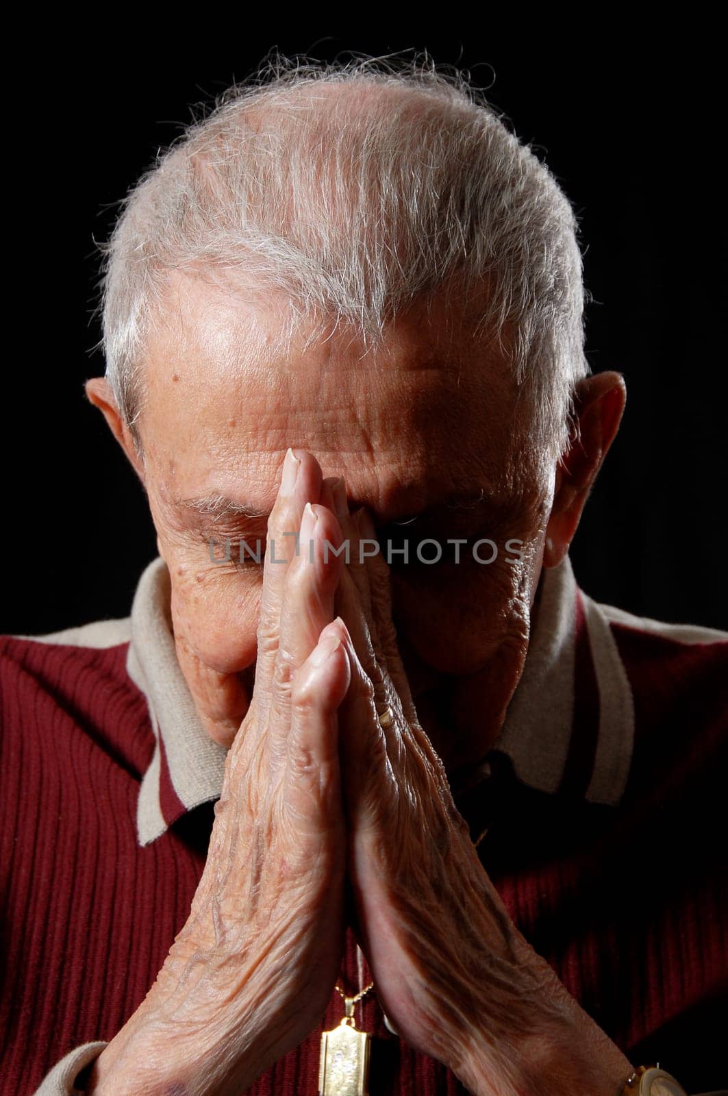 elderly's faith by praying with clasped hands