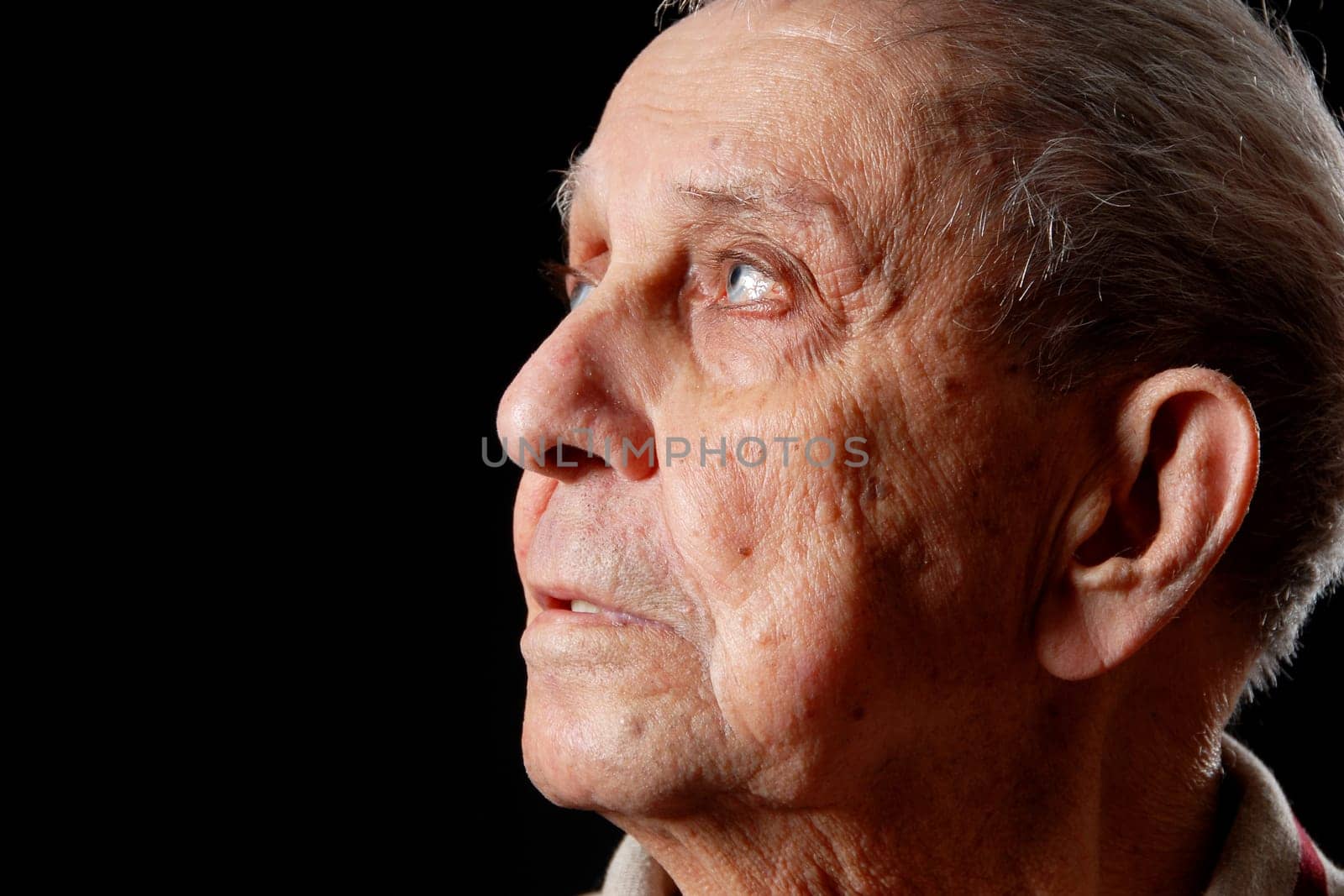 elderly grandfather on a black isolated background
