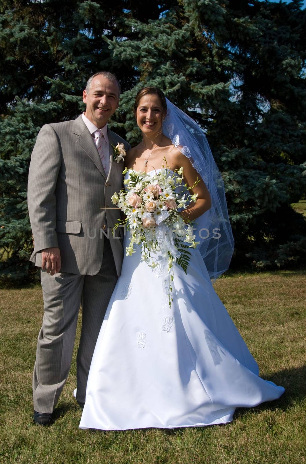 the married couple outside in the grass
