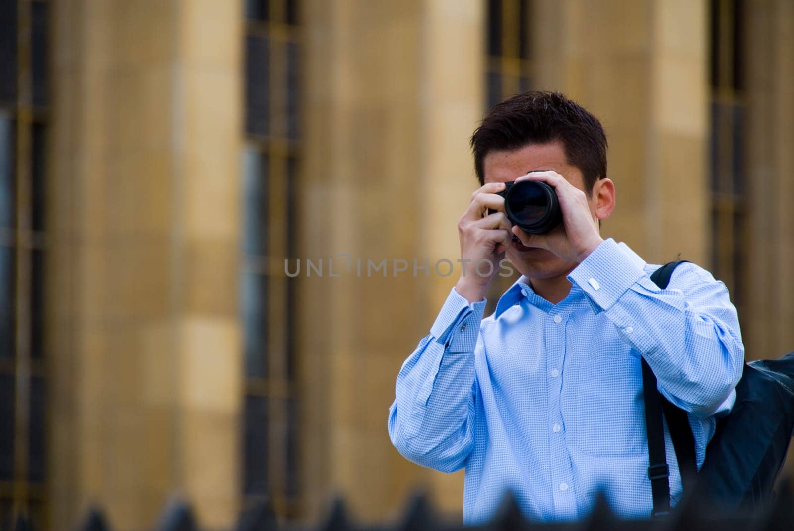 a tourist taking a photo with building