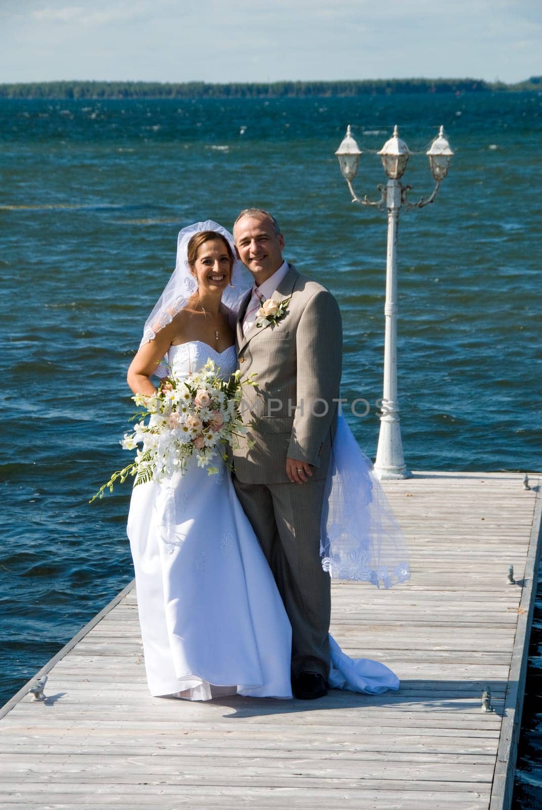 a just married man and woman by a lake