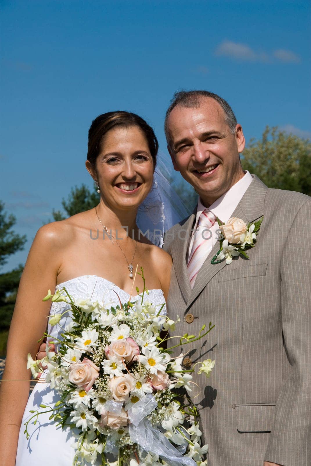 a just married man and woman by a lake