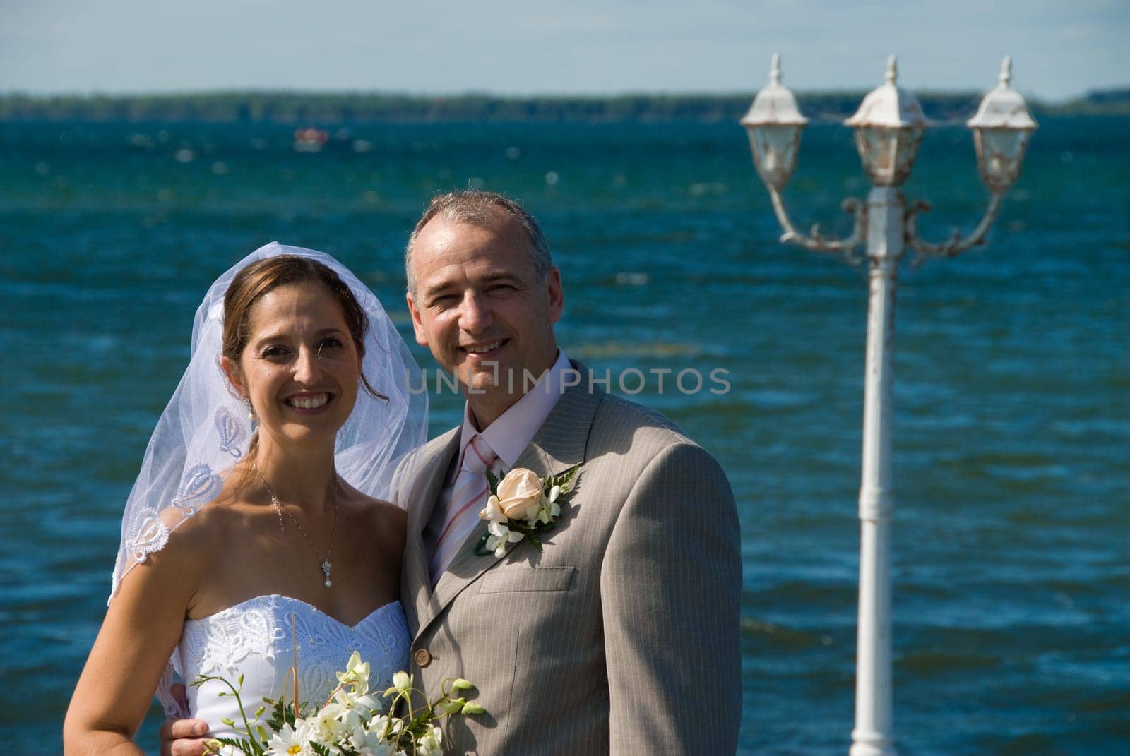 a just married man and woman by a lake