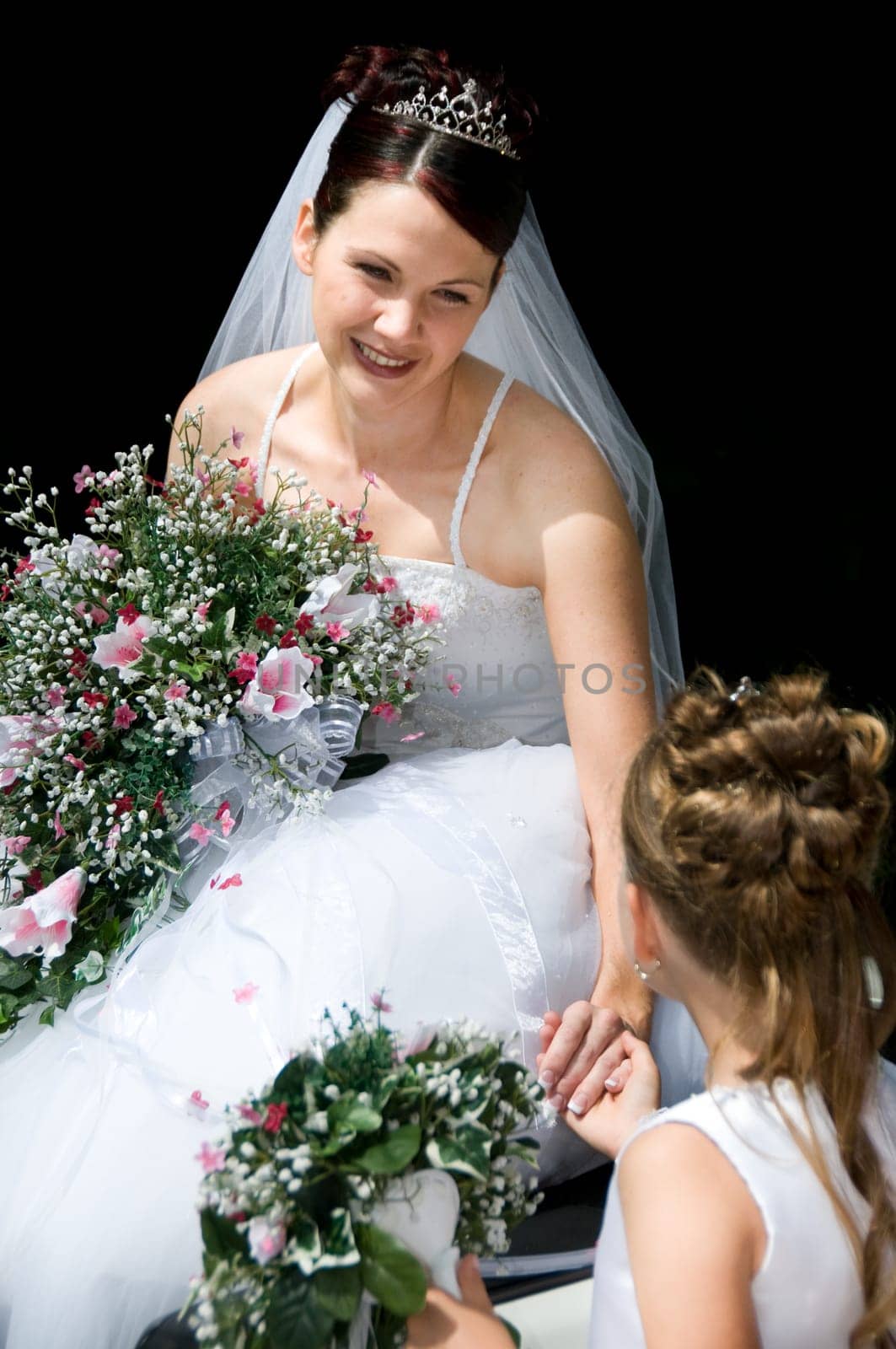 White Bride at her wedding posing with veil
