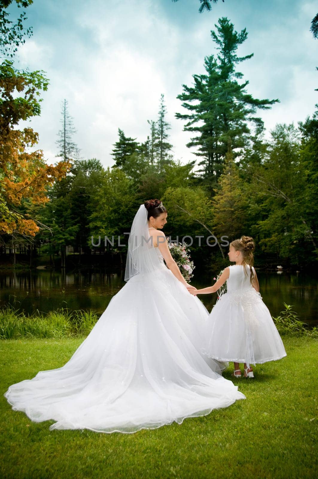 White Bride at her wedding posing with veil