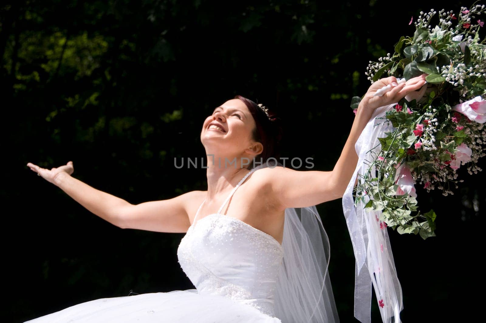 White Bride at her wedding posing with veil