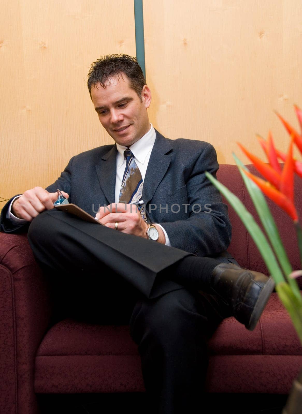 business man taking notes in a reception area