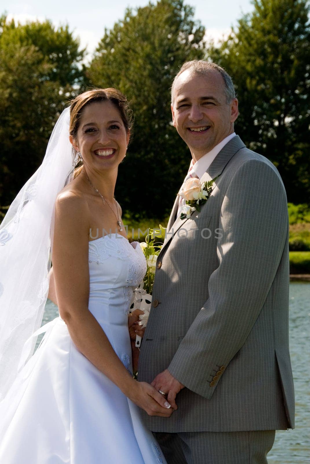 a just married man and woman by a lake