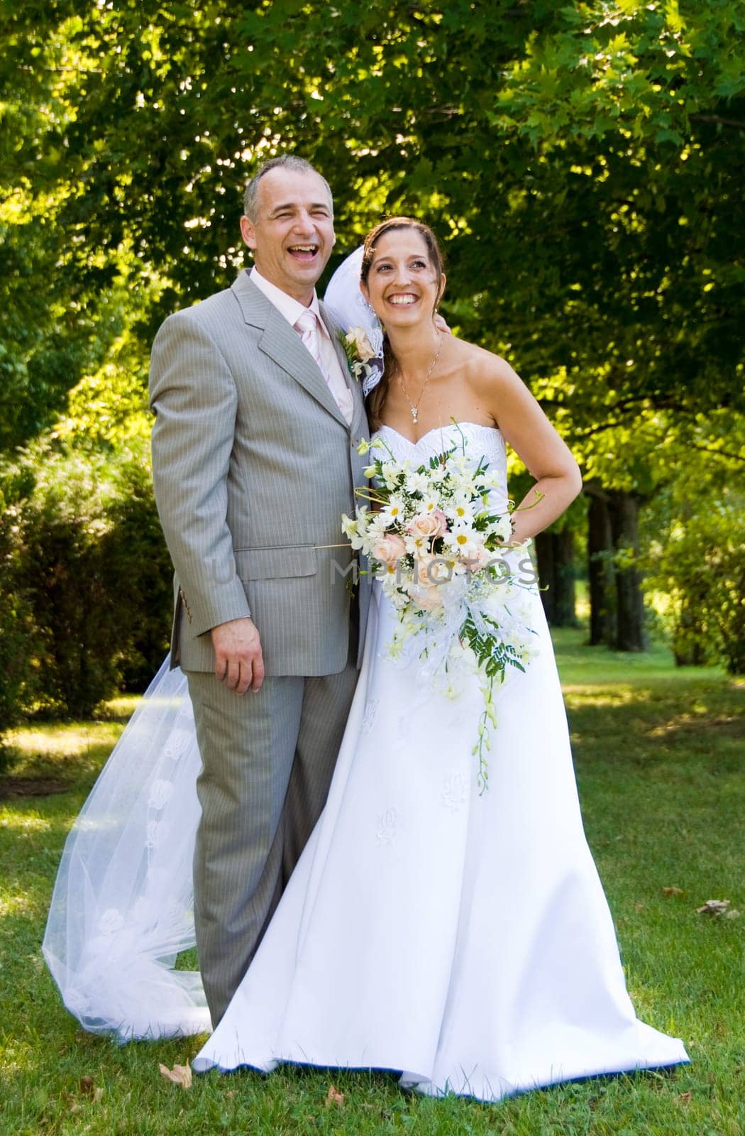 a just married man and woman by some trees