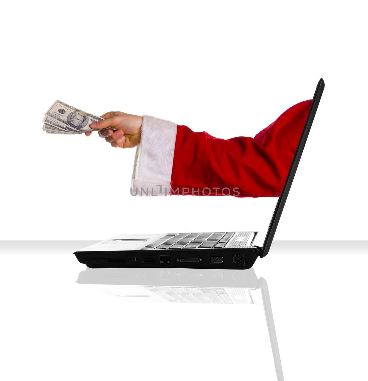 a single laptop on a white table with some xmas money