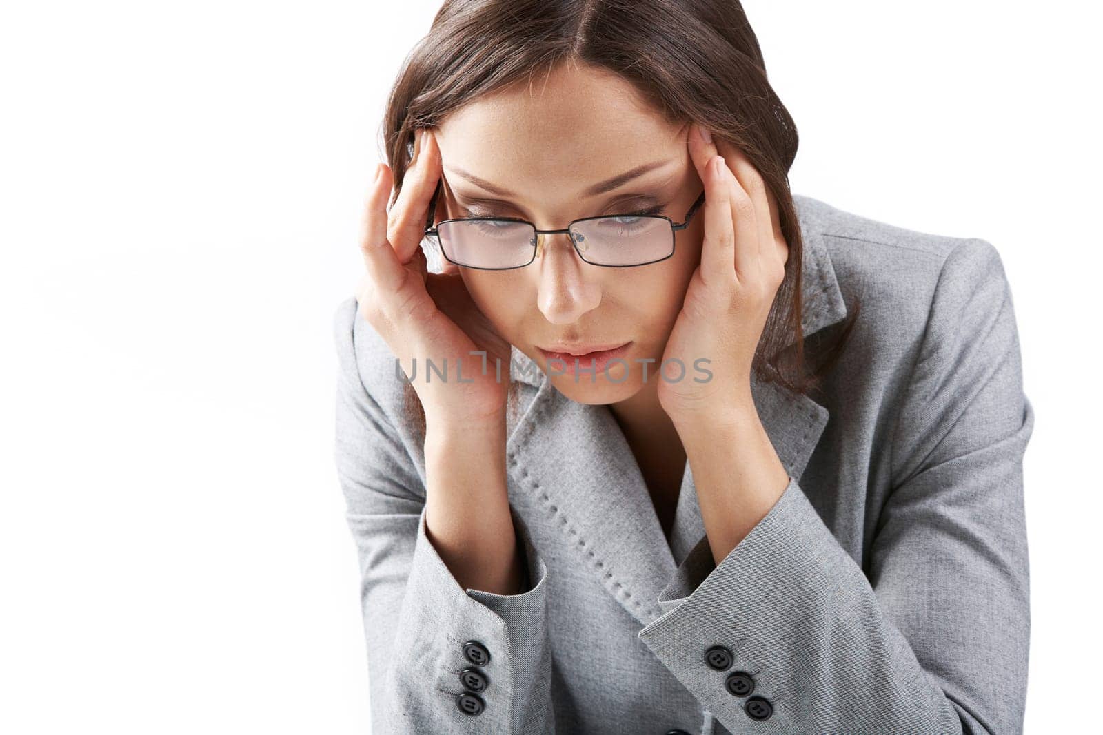 Portrait of a businesswoman in glasses rubbing her temples