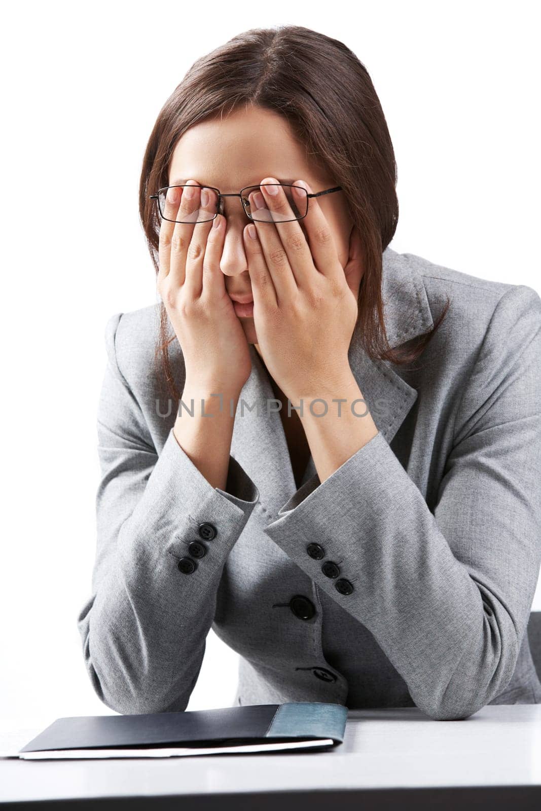 Portrait of a businesswoman in glasses rubbing her eyes