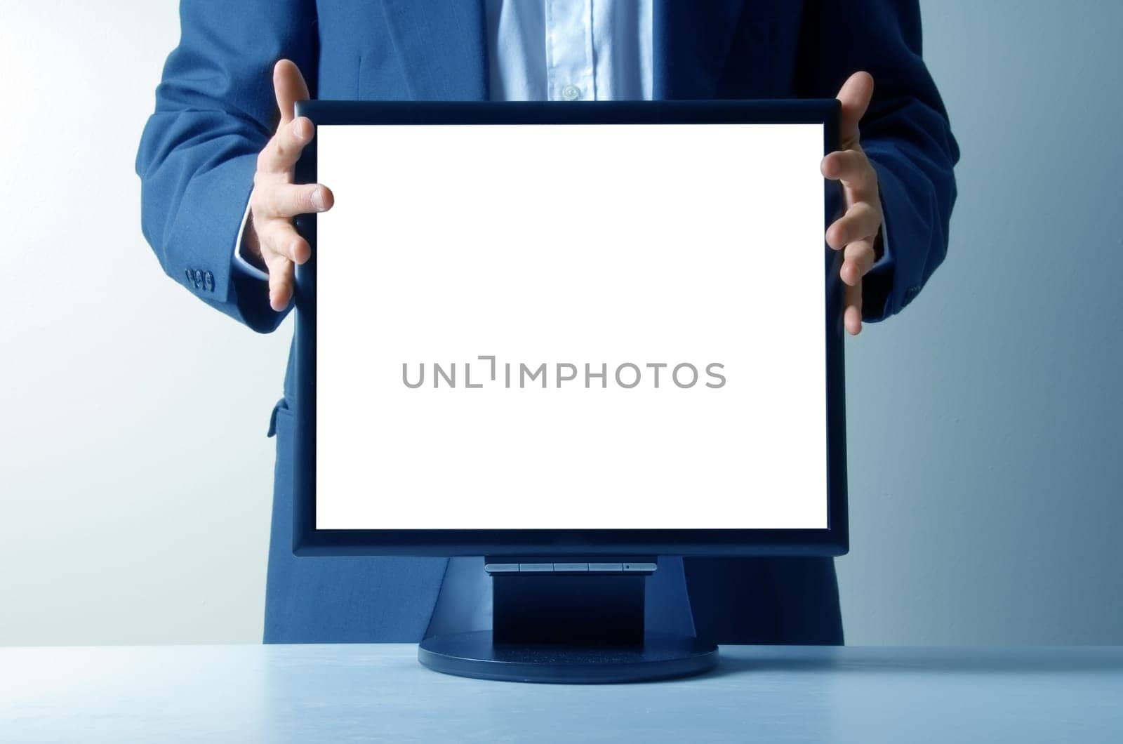 businessman holding an lcd monitor