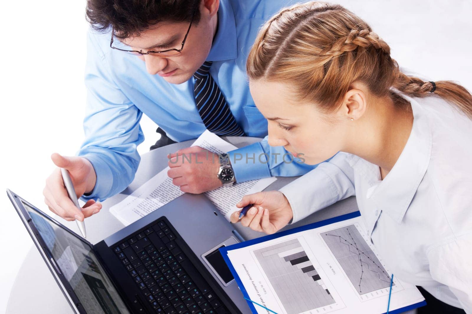 Photo of colleagues looking at laptop and discussing