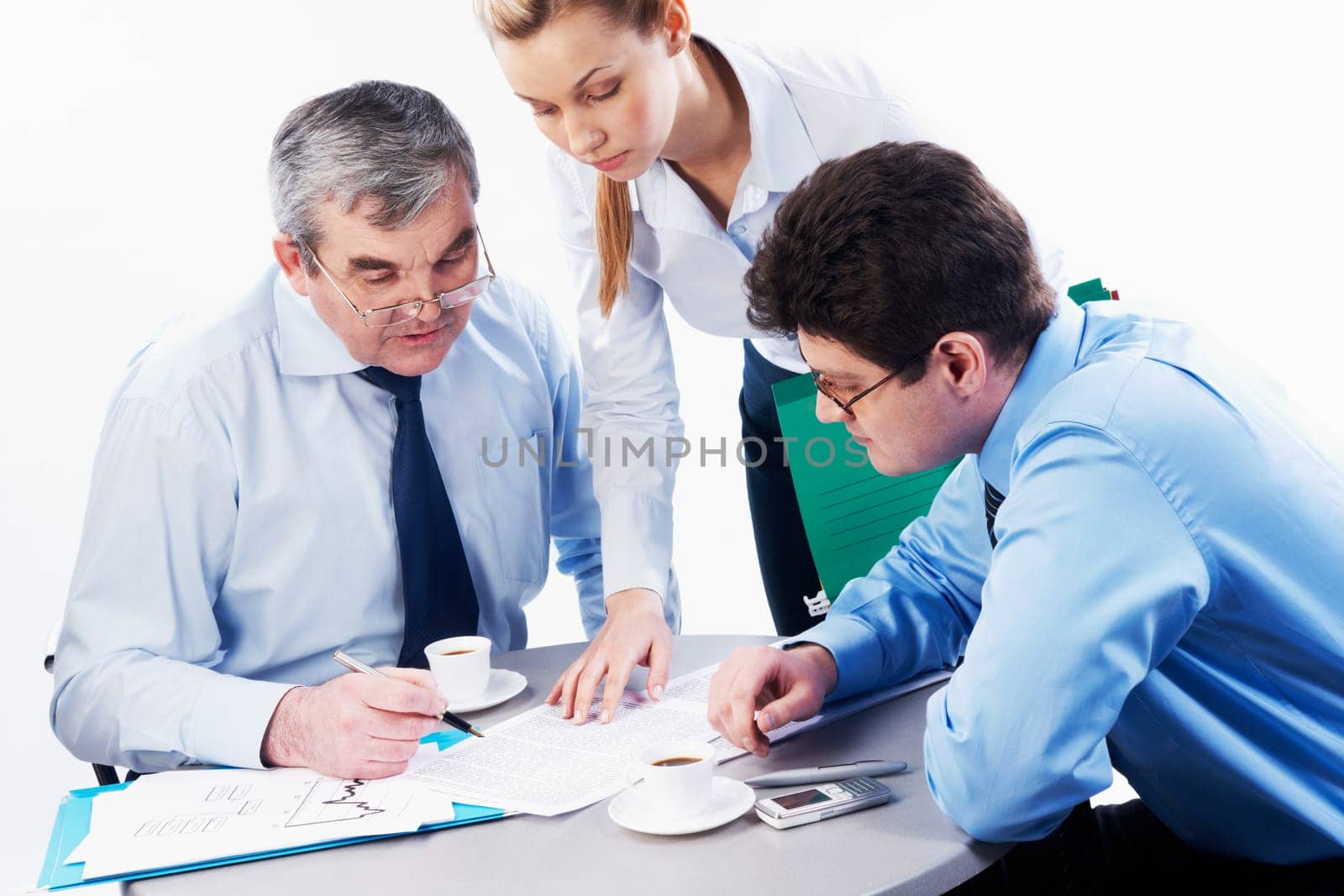 Portrait of serious boss looking at document with two co-workers near by