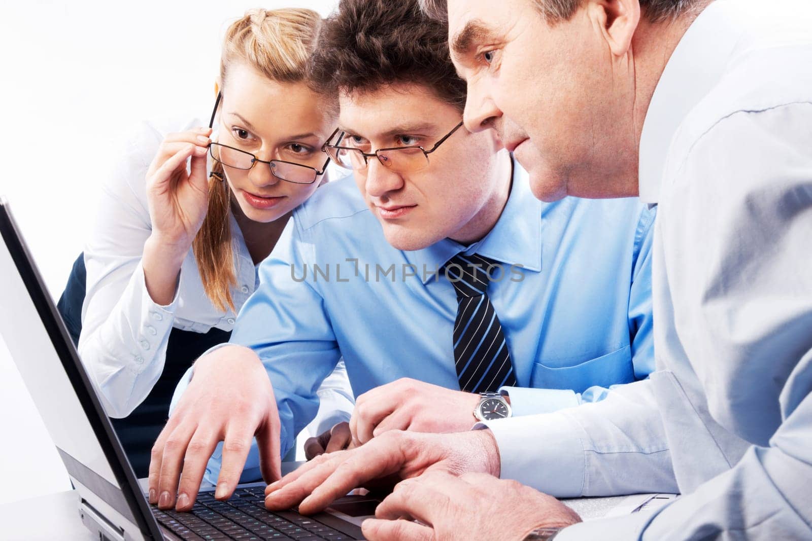 Photo of three businesspeople doing computer work together