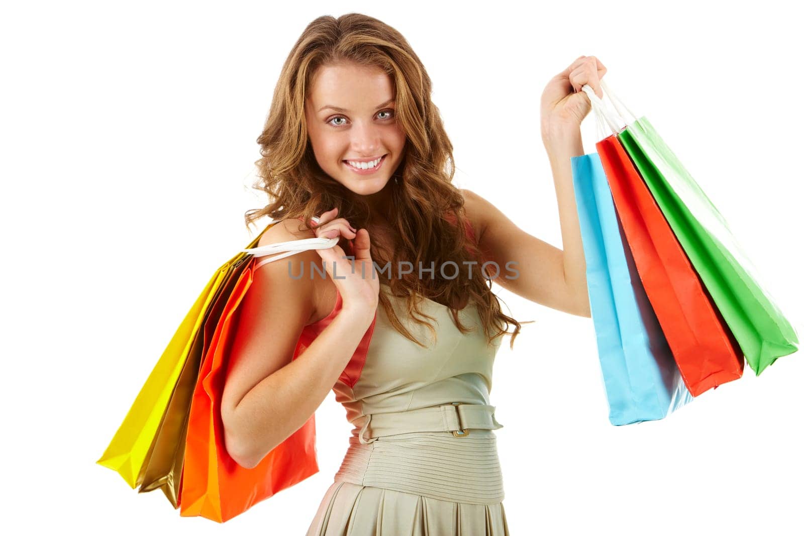 A girl with paper bags looking at camera and smiling