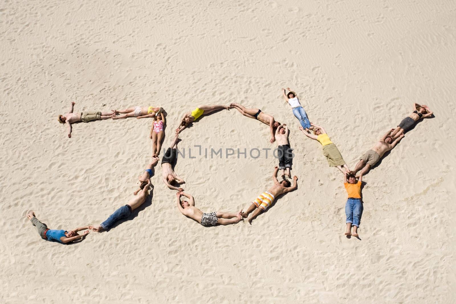 Image of word joy made up of young people resting on the sand