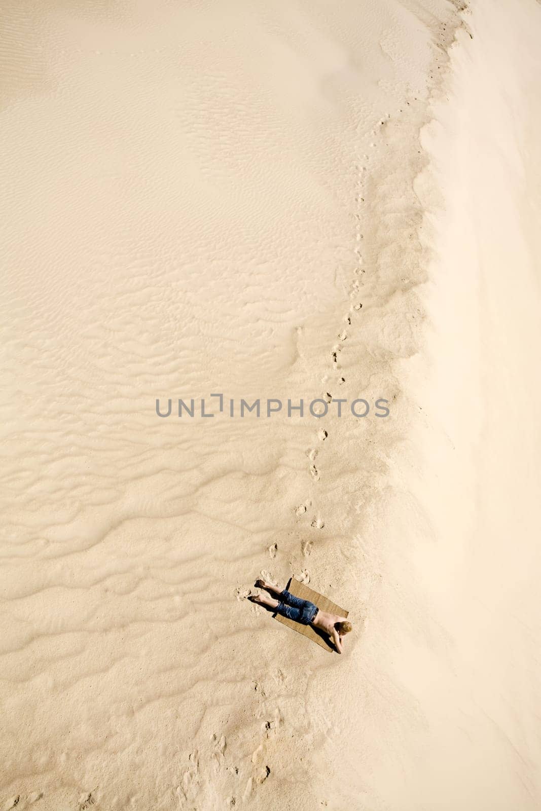 Above view of relaxing man sunbathing on resort