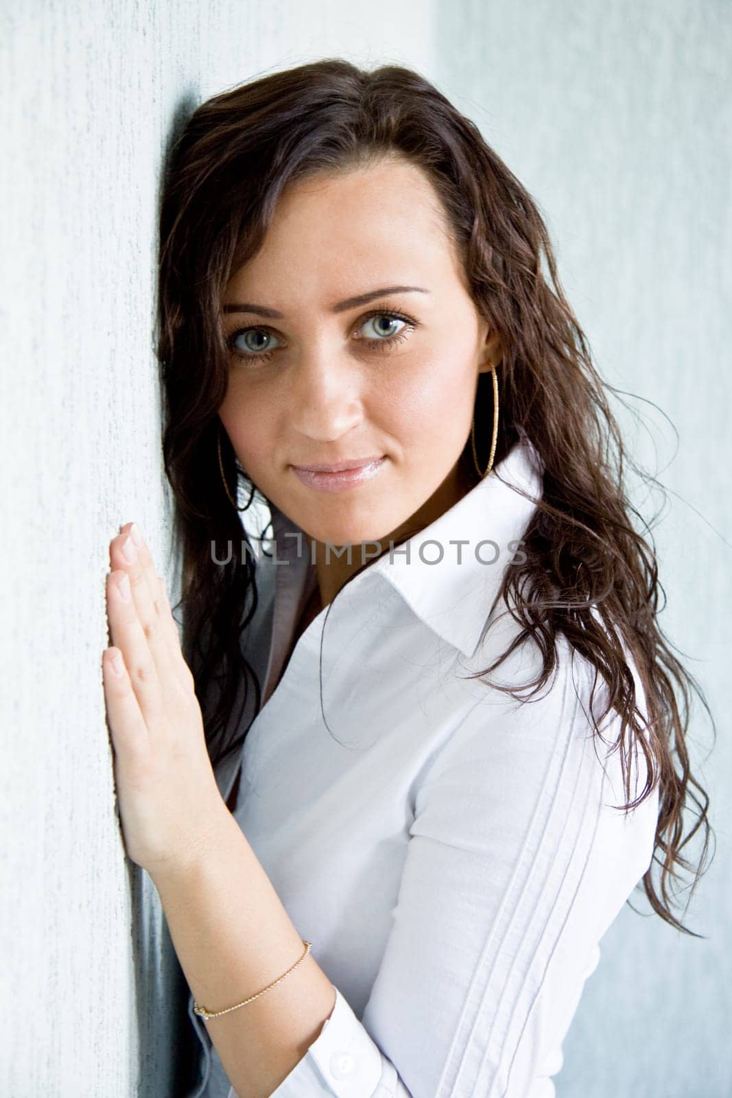 Young charming woman looking at camera with serene expression on her face