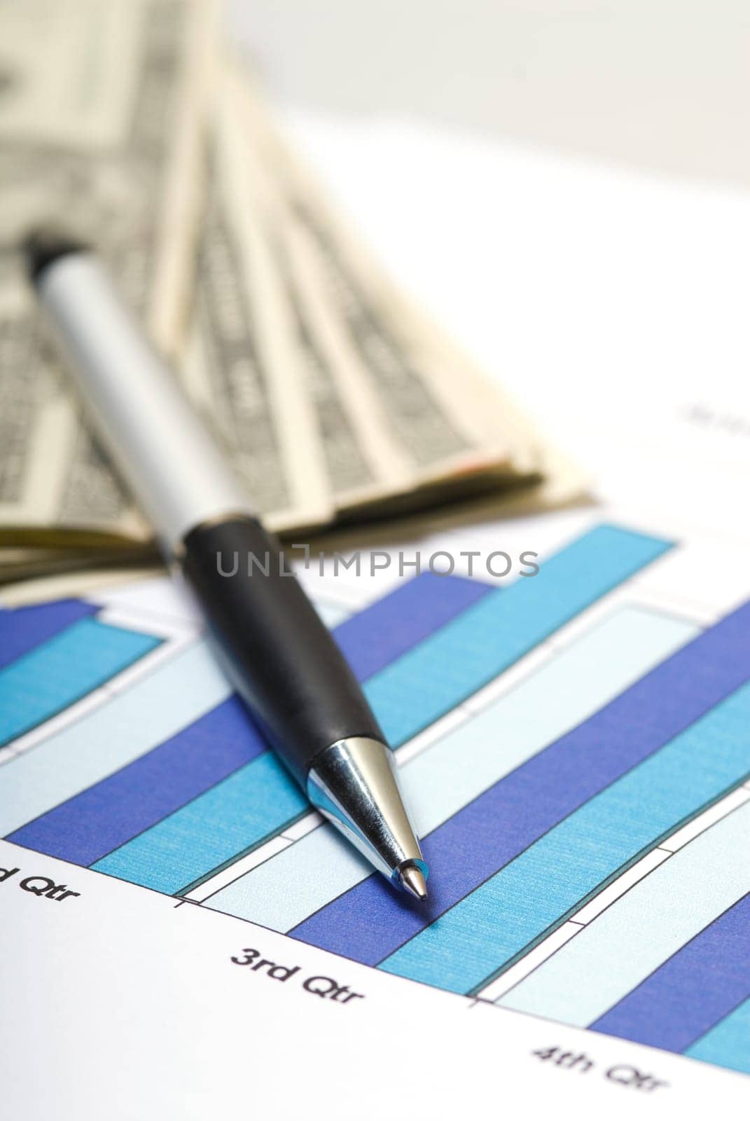 chart with pen and cash on a desk in office